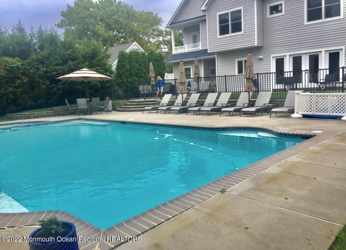 229 Lockwood Avenue Long Branch, NJ 07740 - Photo 12 of 24 a swimming pool with outdoor seating and yard