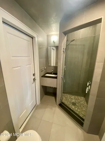 a bathroom with a shower and a sink