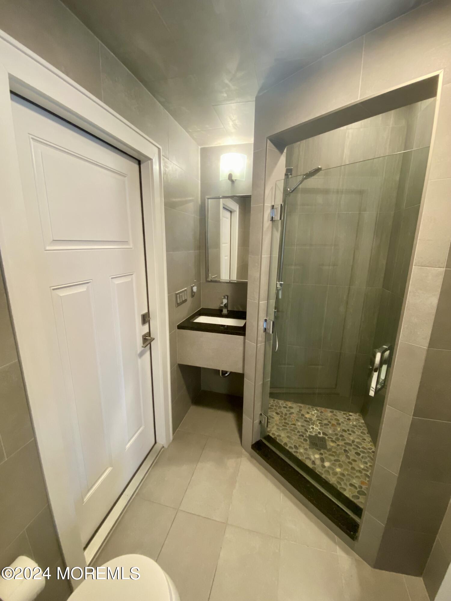 229 Lockwood Avenue Long Branch, NJ 07740 - Photo 15 of 24 a bathroom with a shower and a sink