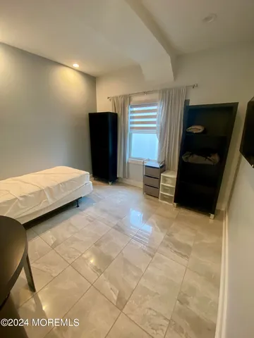 a room with a bed and a television