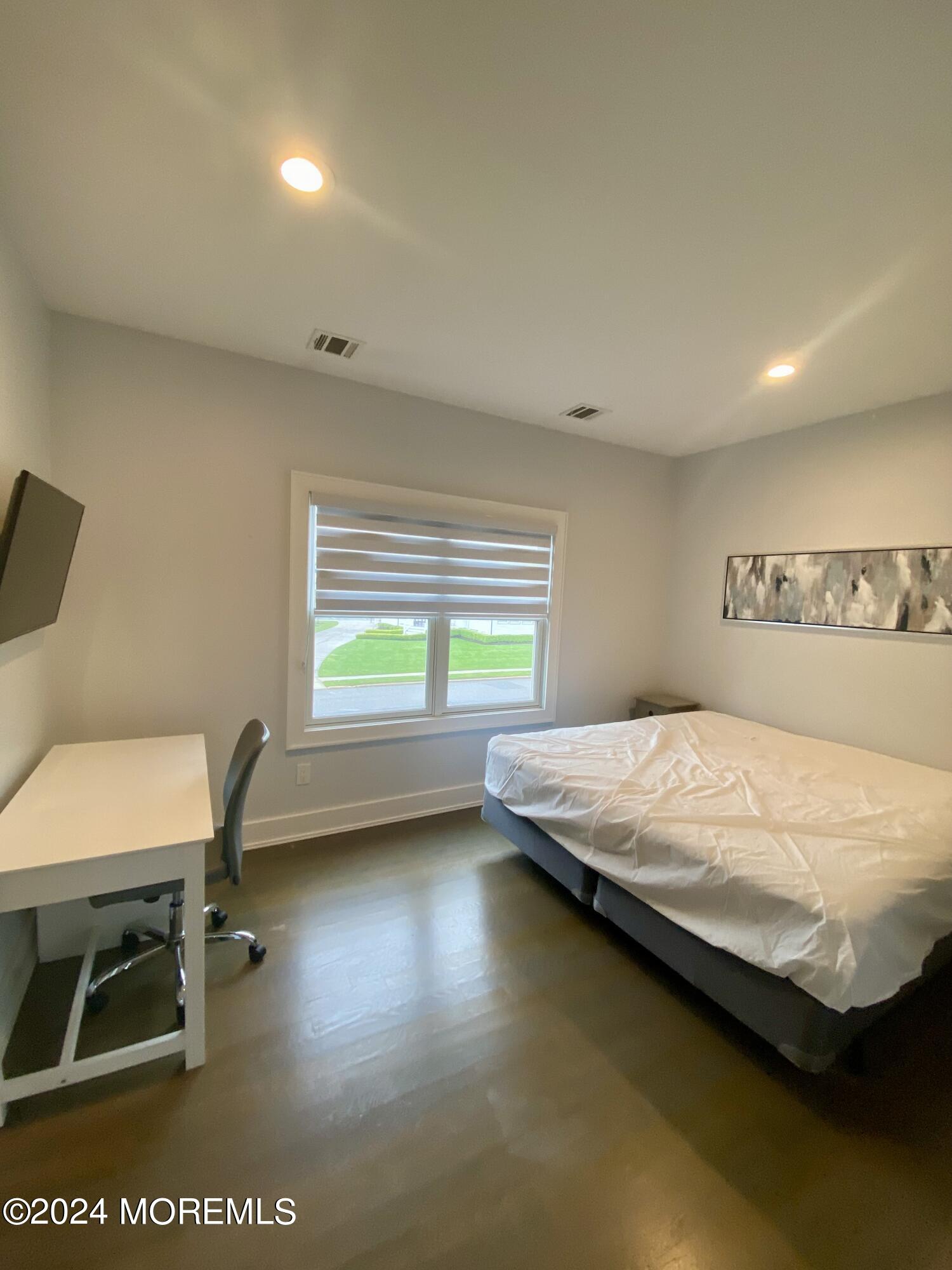 229 Lockwood Avenue Long Branch, NJ 07740 - Photo 17 of 24 a bedroom with a bed and a chair