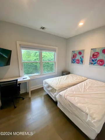 a bedroom with a bed and a desk