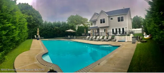 a view of a house with swimming pool and sitting area