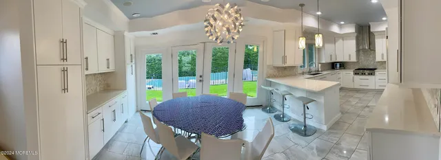 a spacious bathroom with a tub sink and glass door