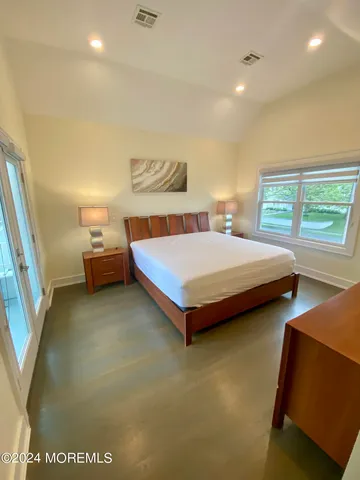 a bedroom with a bed and a night stand