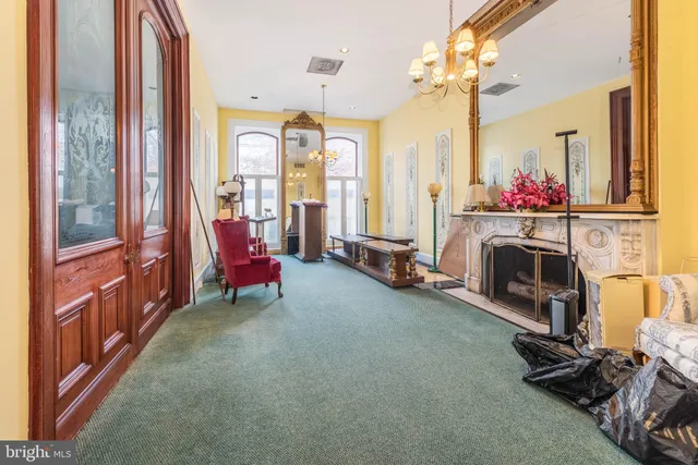 a view of a living room with furniture and a fireplace
