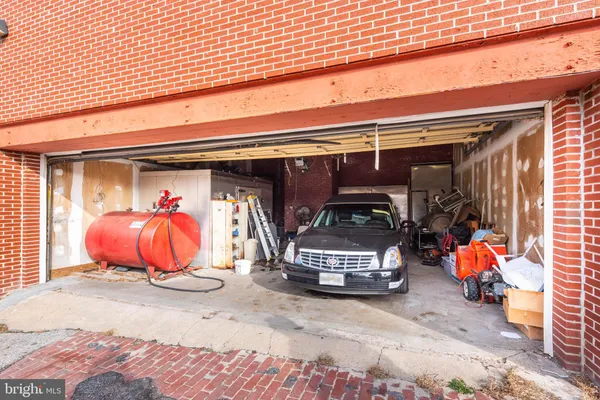 a front view of a building with large trees
