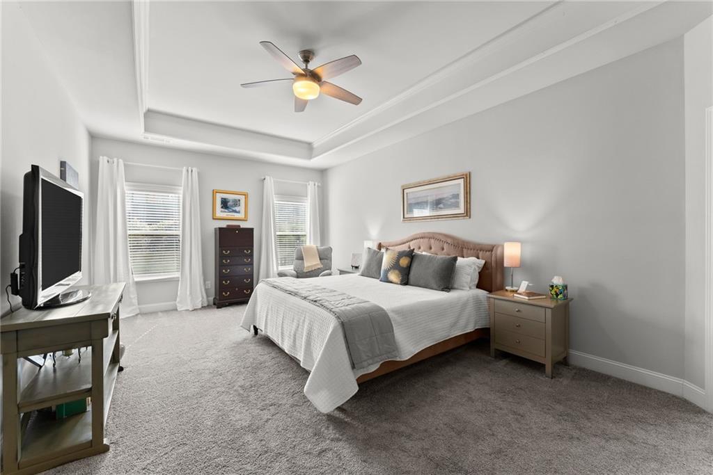 527 Gadwall Circle Jefferson, GA 30549 - Photo 17 of 48 a spacious bedroom with a bed and a flat screen tv