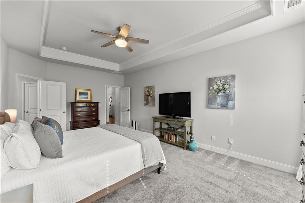 527 Gadwall Circle Jefferson, GA 30549 - Photo 19 of 48 a bedroom with a bed and a flat screen tv