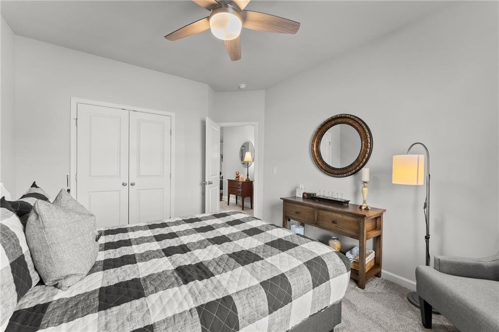 527 Gadwall Circle Jefferson, GA 30549 - Photo 28 of 48 a bedroom with a bed and a chandelier