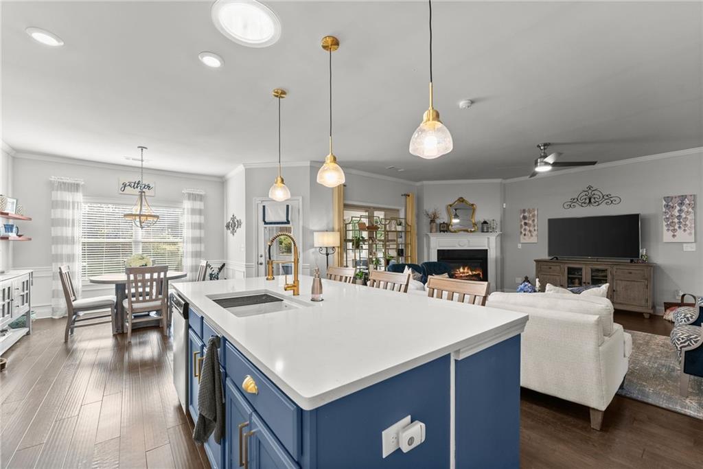 527 Gadwall Circle Jefferson, GA 30549 - Photo 8 of 48 a kitchen with stainless steel appliances kitchen island granite countertop a stove a sink a dining table and chairs with wooden floor