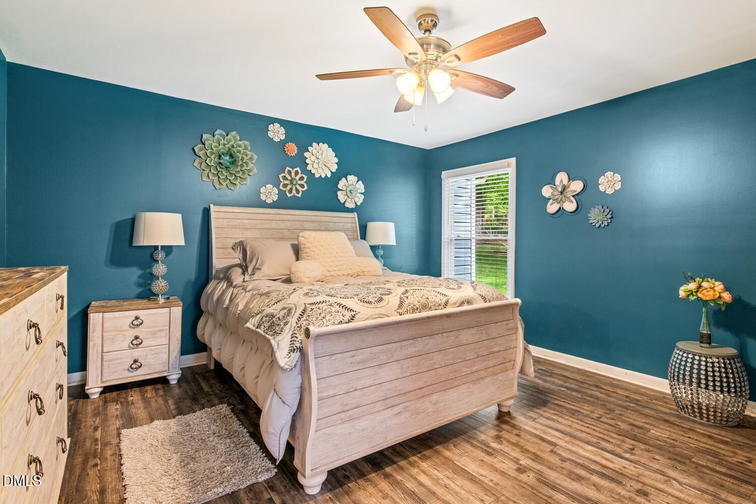 134 Longview Road Madison, NC 27025 - Photo 26 of 49 a bedroom with a bed and a chandelier