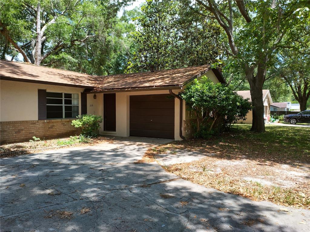 1209 Southwest 80th Drive Gainesville, FL 32607 - Photo 1 of 32 a backyard of a house with table and chairs