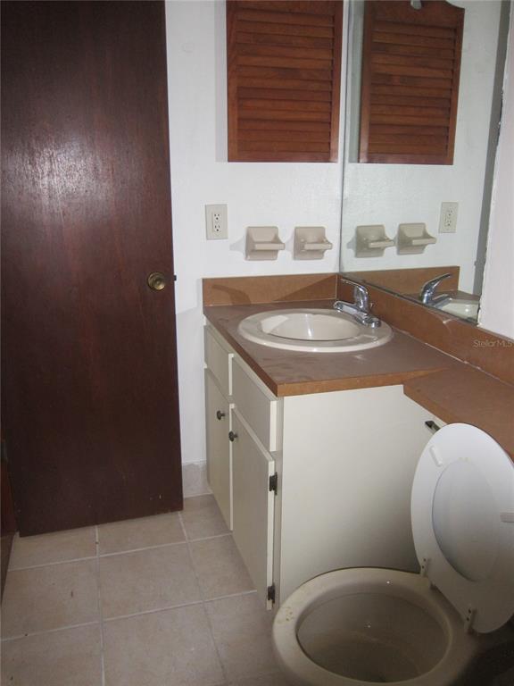 1209 Southwest 80th Drive Gainesville, FL 32607 - Photo 14 of 32 a bathroom with a sink toilet and mirror