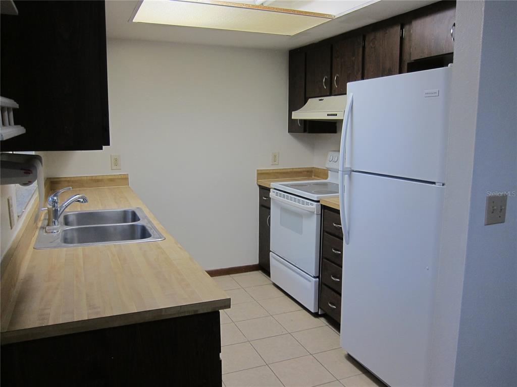 1209 Southwest 80th Drive Gainesville, FL 32607 - Photo 18 of 32 a white refrigerator freezer sitting in a kitchen
