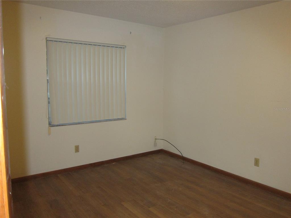 1209 Southwest 80th Drive Gainesville, FL 32607 - Photo 30 of 32 an empty room with a bench