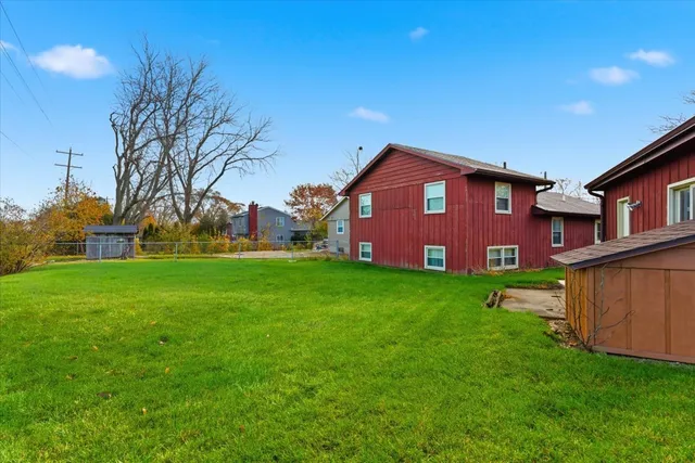 a view of a big house with a big yard