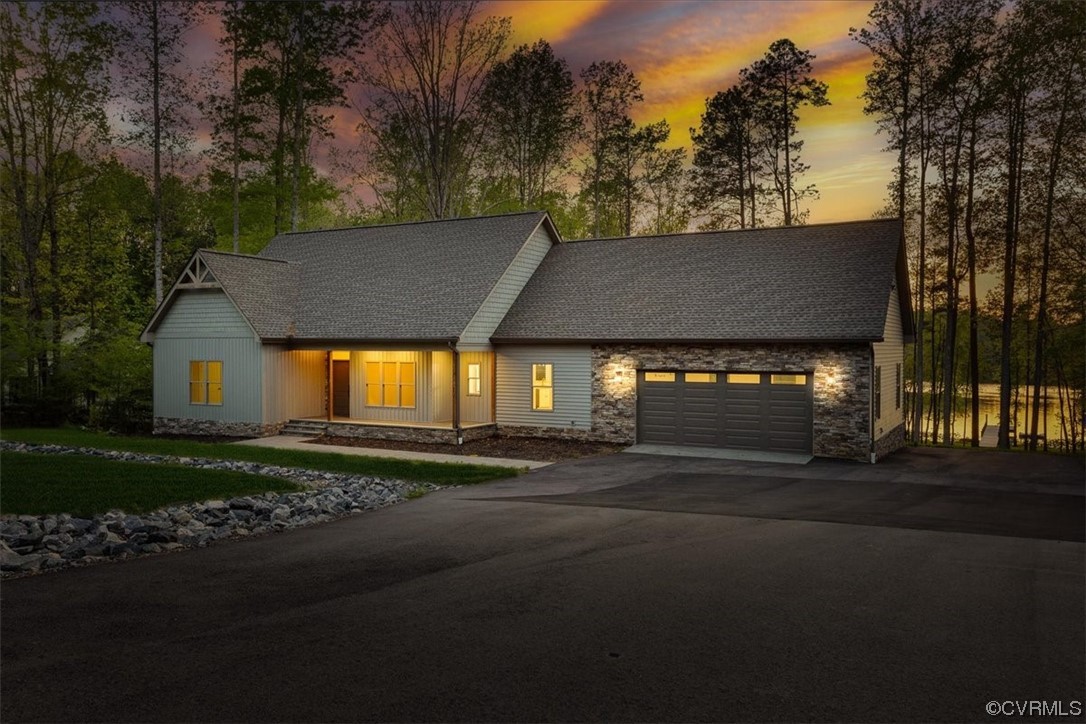 a view of a house with a yard and street
