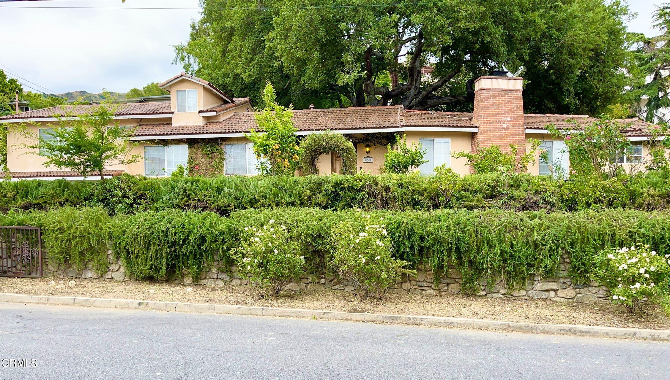 a front view of a house with a yard and lake view