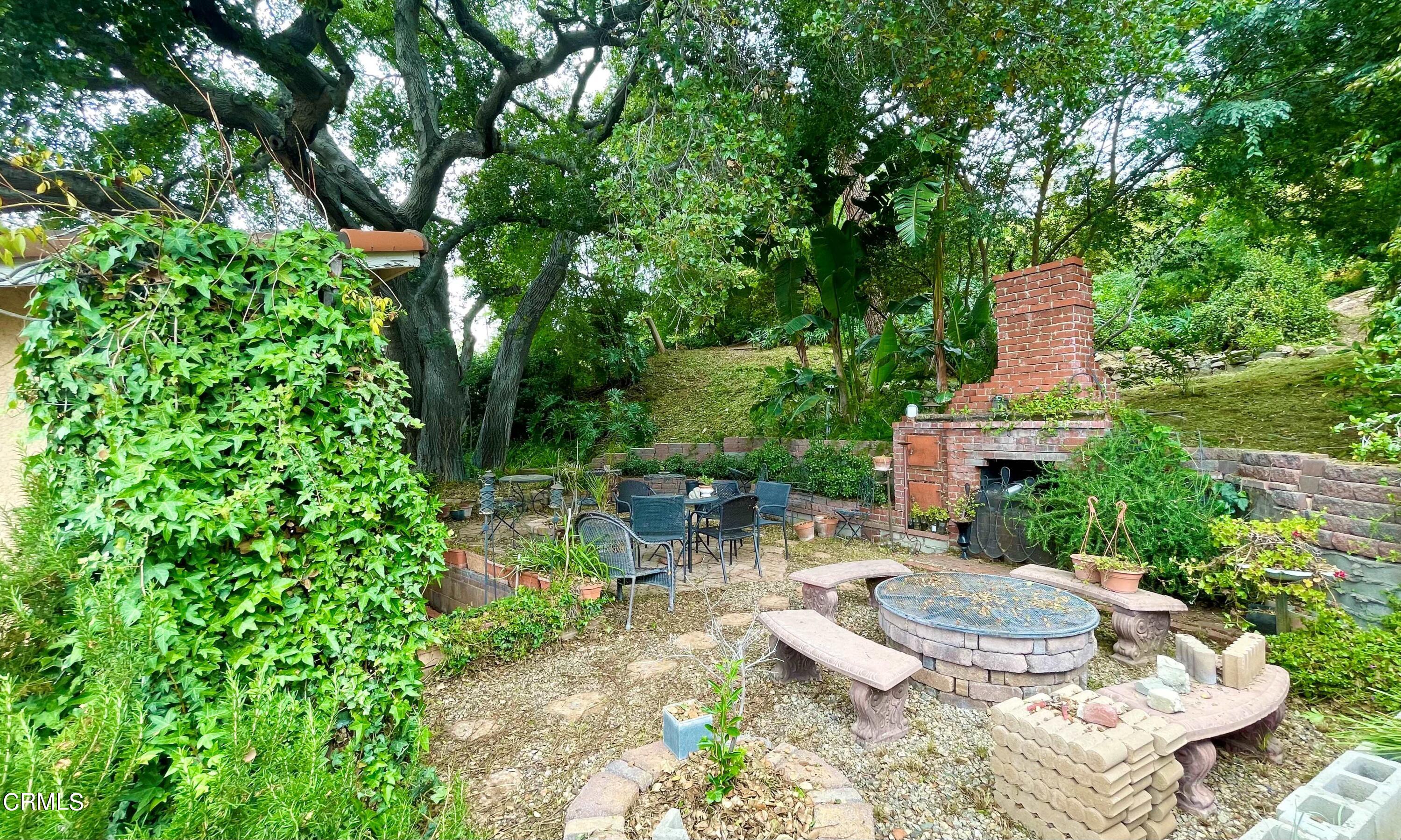 930 Sherlock Drive Burbank, CA 91501 - Photo 11 of 21 a view of a patio with table and chairs potted plants and large tree