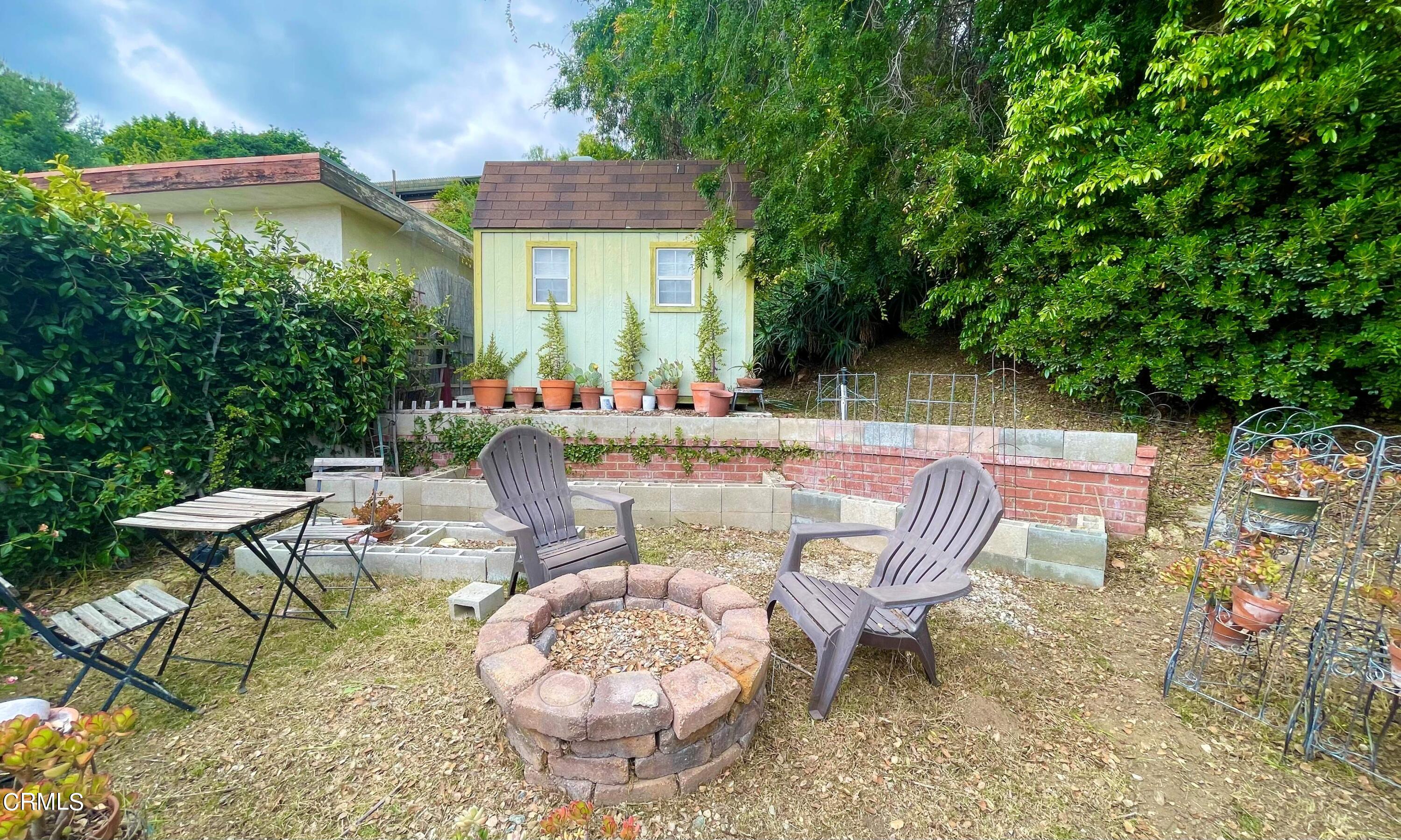 930 Sherlock Drive Burbank, CA 91501 - Photo 15 of 21 a view of a patio with table and chairs and potted plants
