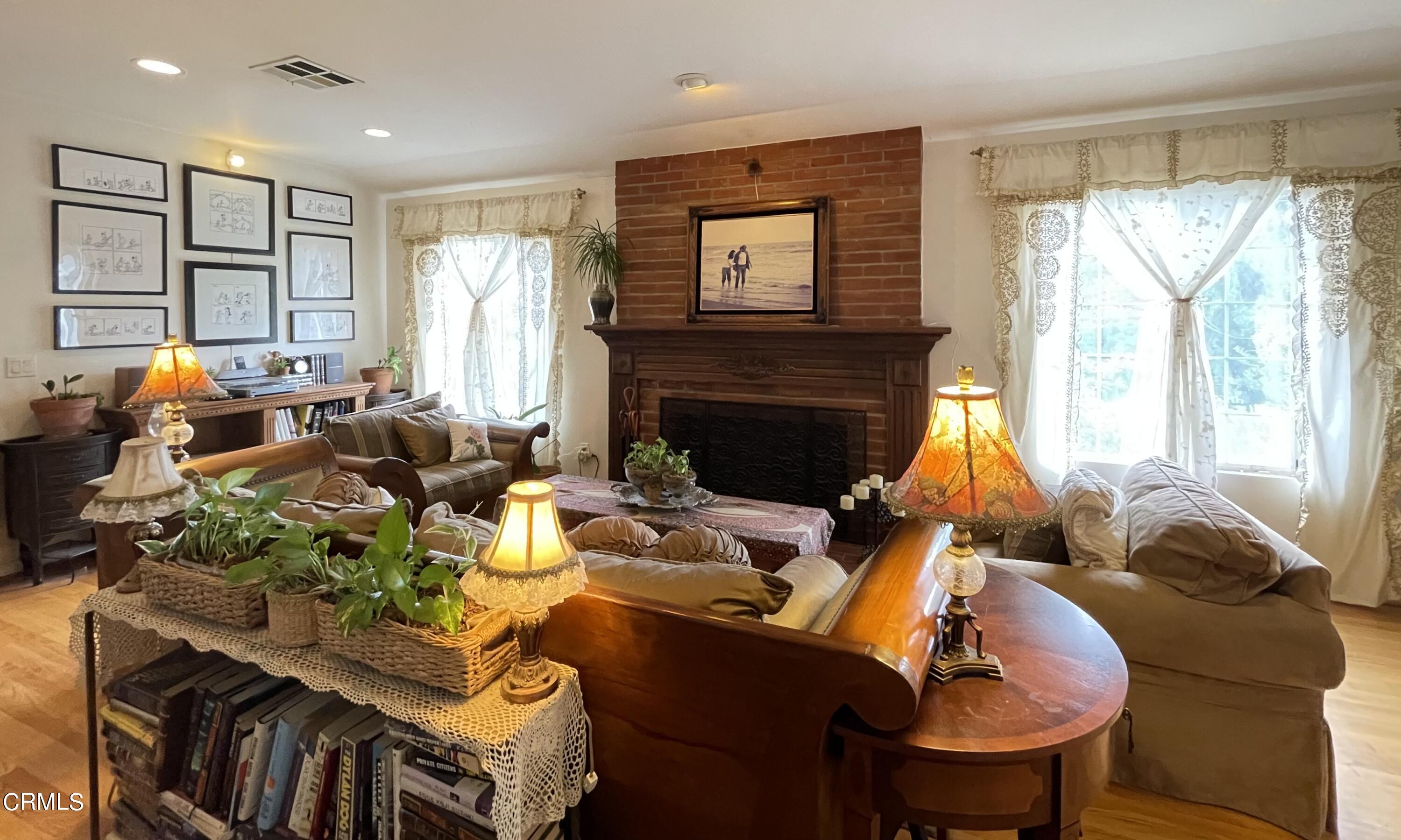 930 Sherlock Drive Burbank, CA 91501 - Photo 5 of 21 a living room with furniture fireplace and a large window