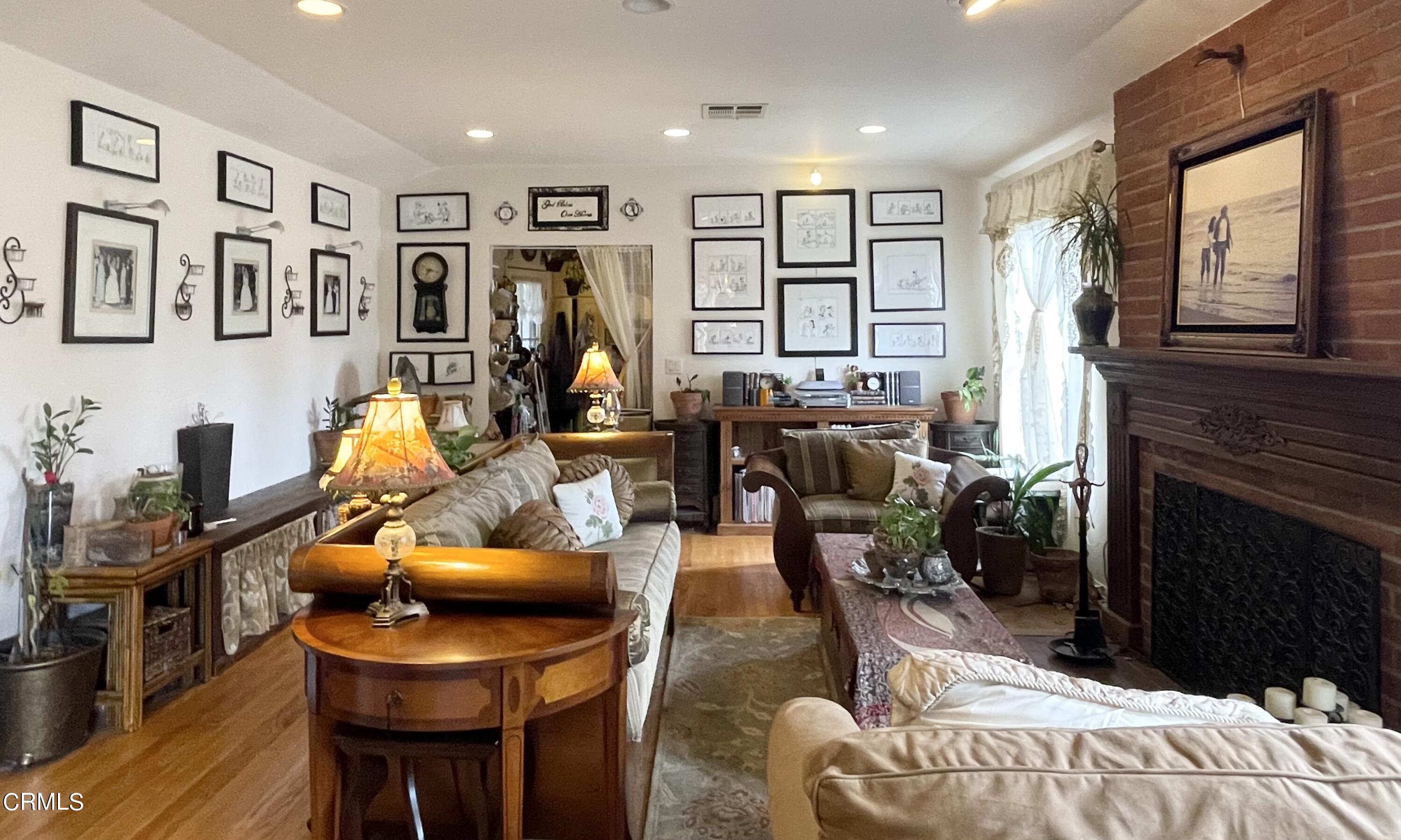 930 Sherlock Drive Burbank, CA 91501 - Photo 7 of 21 a living room with furniture a flat screen tv and a fireplace