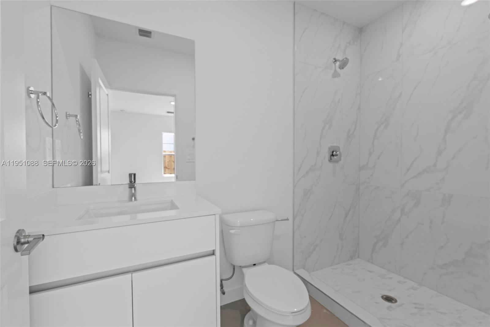 13350 Southwest 272nd Street Homestead, FL 33032 - Photo 18 of 35 a bathroom with a sink a toilet and shower