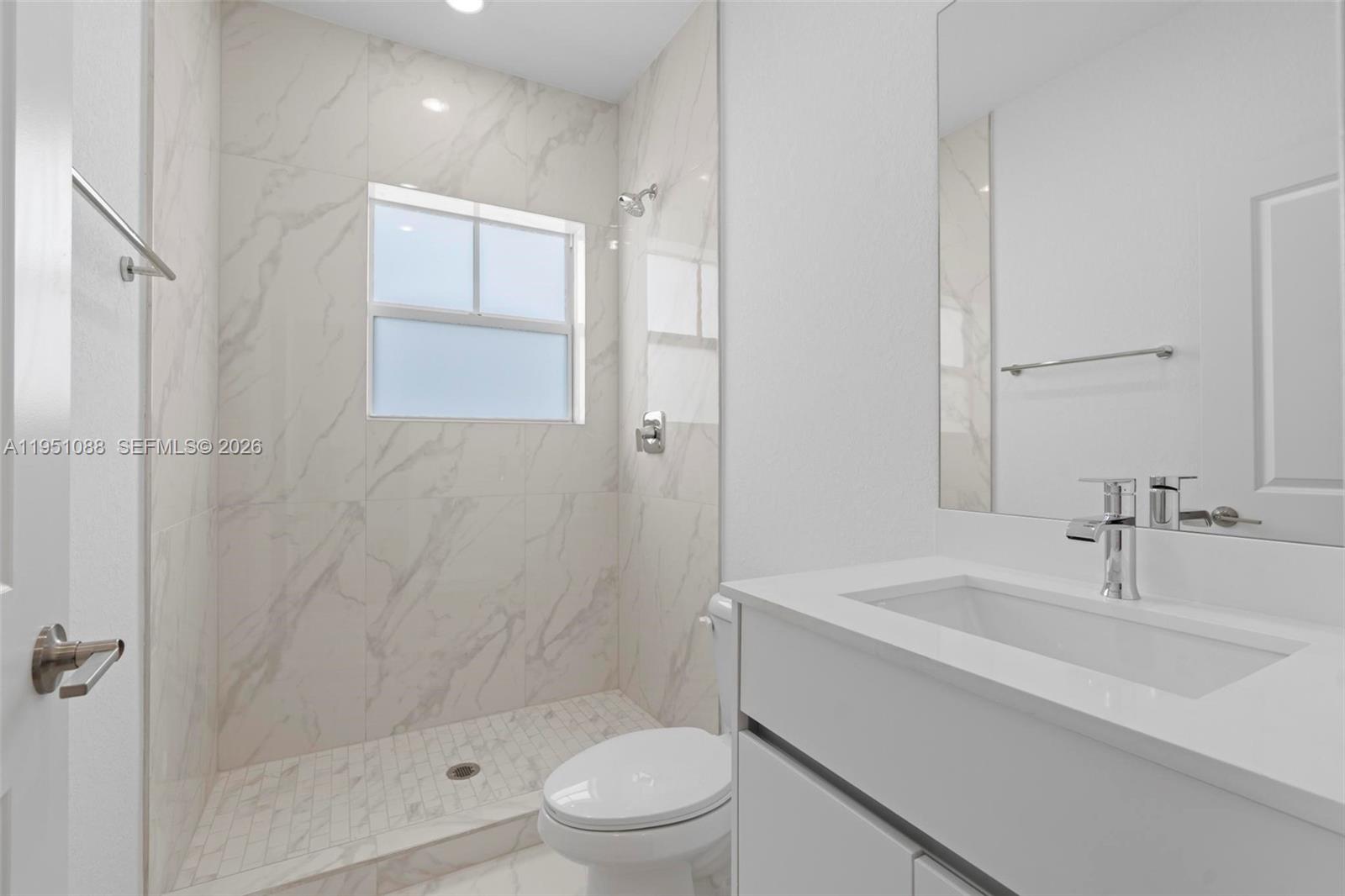 13350 Southwest 272nd Street Homestead, FL 33032 - Photo 29 of 35 a bathroom with a sink a toilet and shower