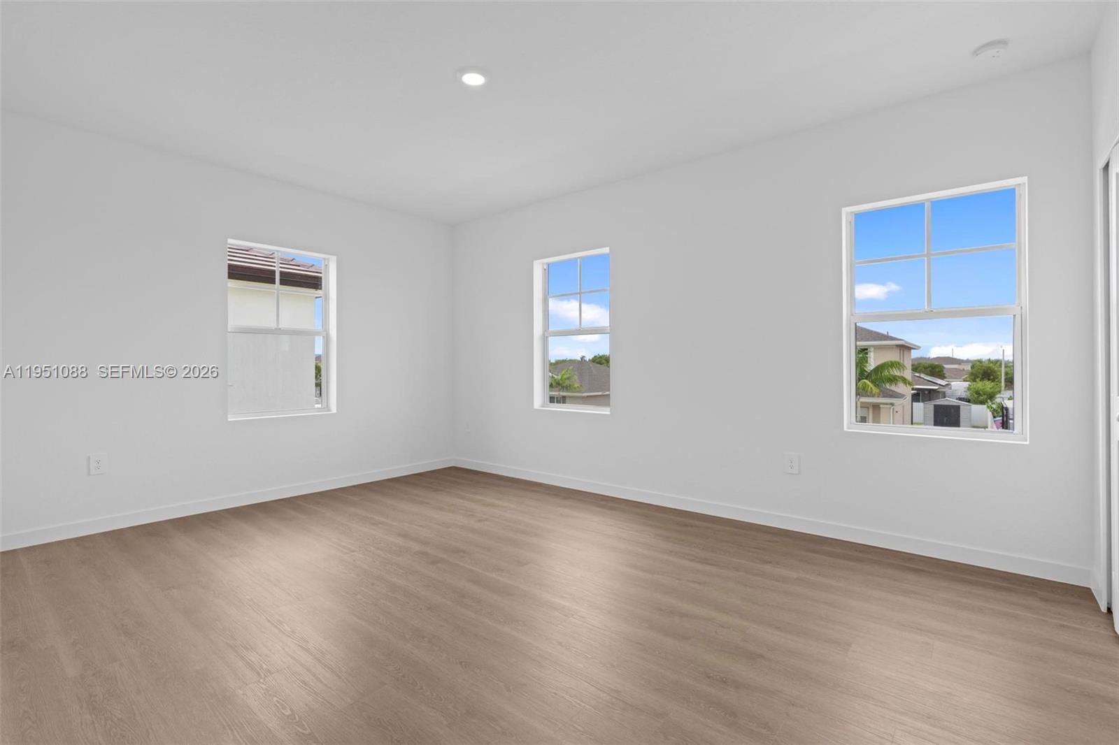 13350 Southwest 272nd Street Homestead, FL 33032 - Photo 30 of 35 a view of an empty room with wooden floor and a window