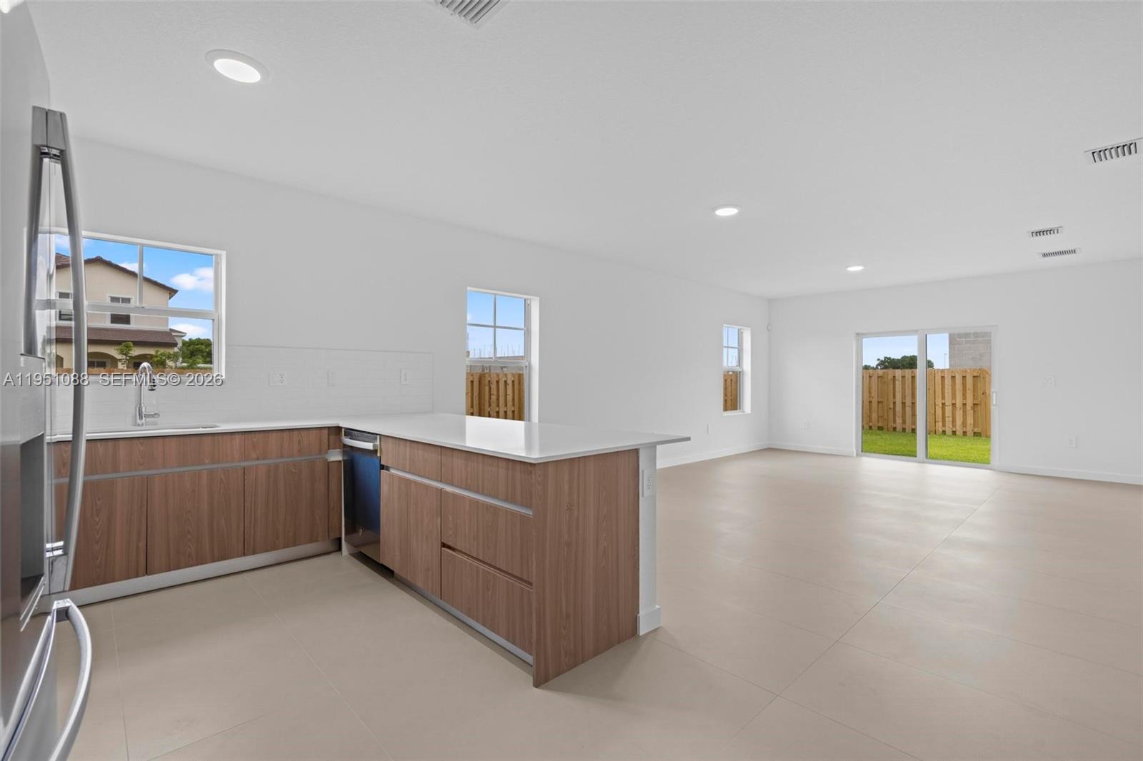 13350 Southwest 272nd Street Homestead, FL 33032 - Photo 5 of 35 a view of an empty room with window and cabinet