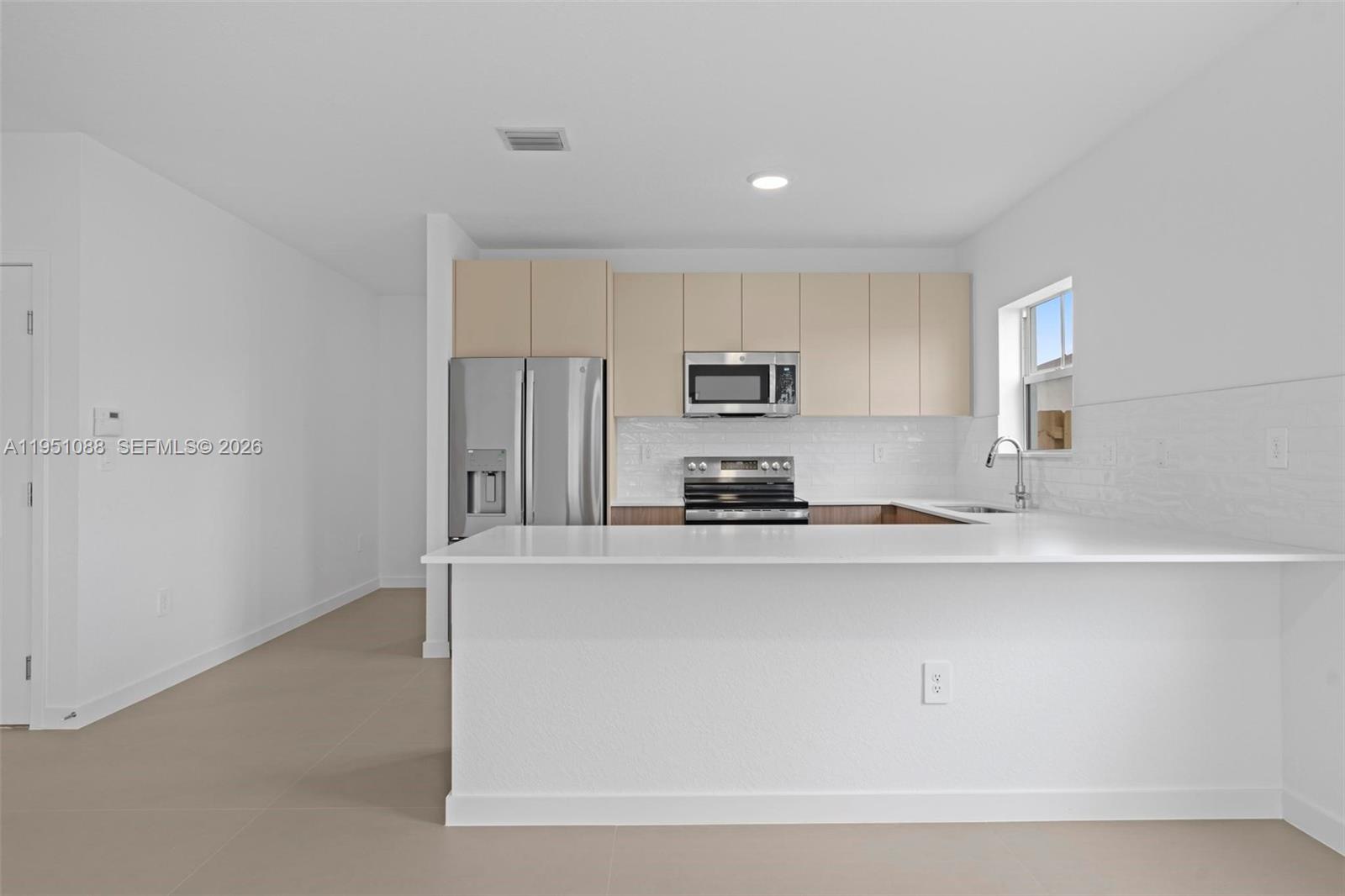 13350 Southwest 272nd Street Homestead, FL 33032 - Photo 10 of 35 a large kitchen with cabinets and stainless steel appliances