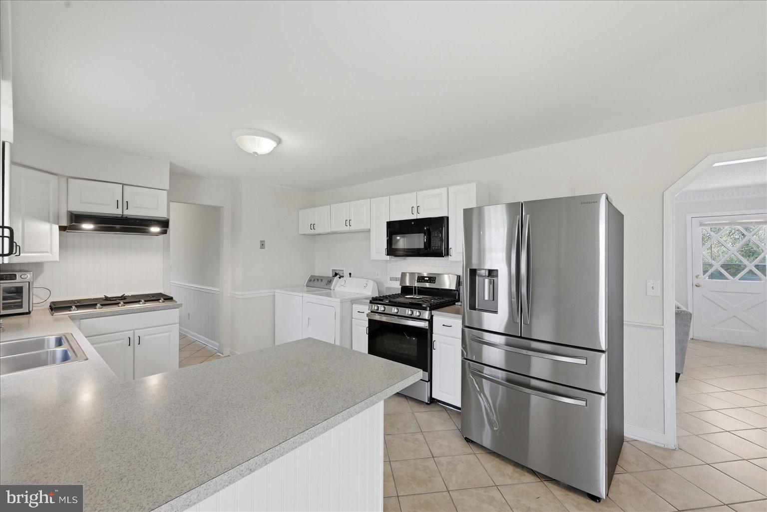 613 Overlook Street Culpeper, VA 22701 - Photo 5 of 15 a kitchen with stainless steel appliances granite countertop a refrigerator sink and stove
