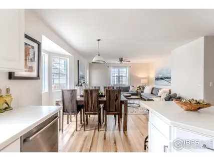 a living room with lots of furniture and a wooden floor