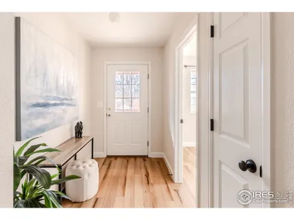a view of an entryway with wooden floor