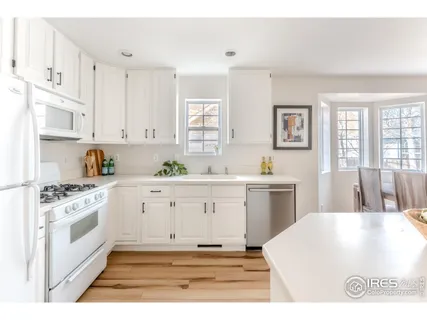 a kitchen with cabinets appliances and a window