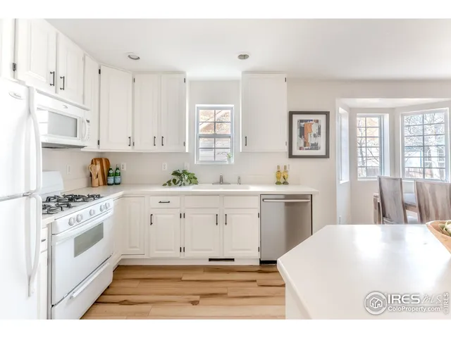 a kitchen with cabinets appliances and a window