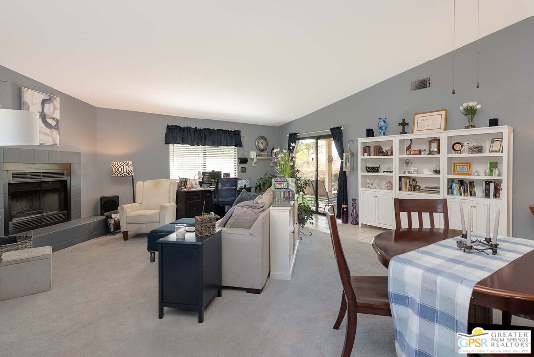 9760 Capiland Road Desert Hot Springs, CA 92240 - Photo 6 of 16 a living room with furniture and a fireplace