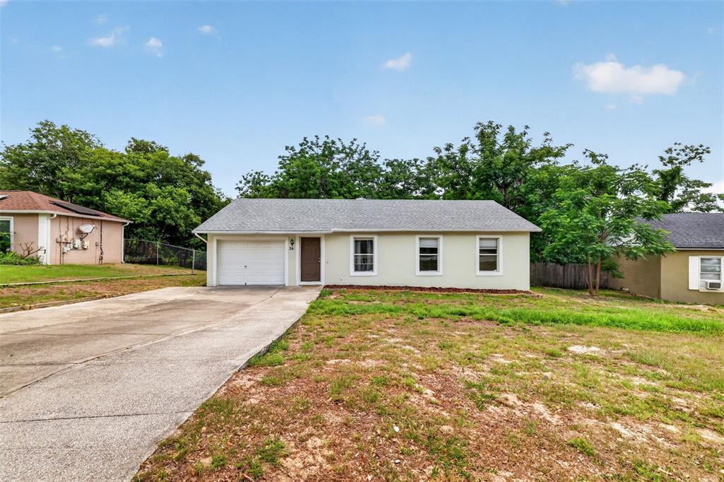36 Bay Ridge Loop Mascotte, FL 34753 - Photo 2 of 32 a view of a house next to a yard with big trees