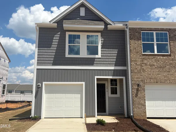 a front view of a house with a garage