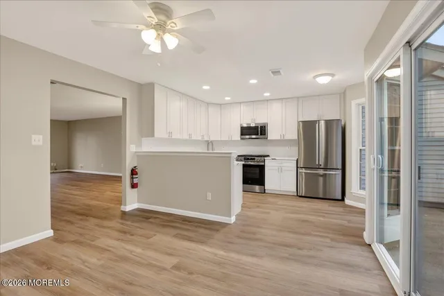 a kitchen with stainless steel appliances granite countertop a refrigerator and a sink