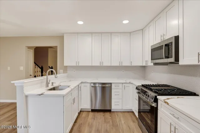 a kitchen with a sink stove top oven and cabinets
