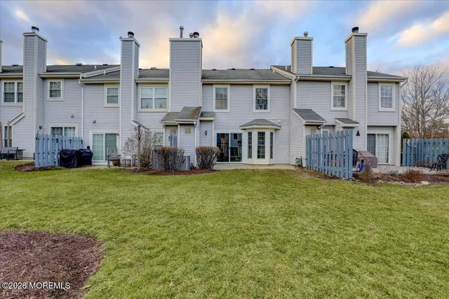 a front view of a house with a garden and plants