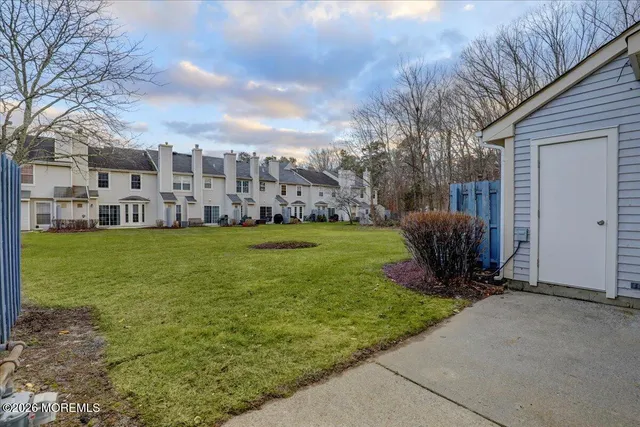 a view of a house with backyard and sitting area