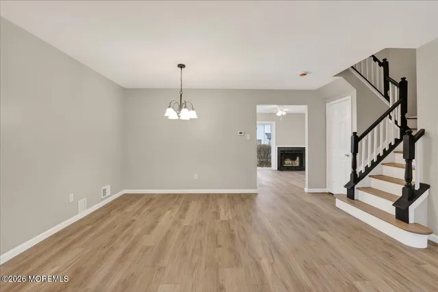 a view of empty room with wooden floor and stove
