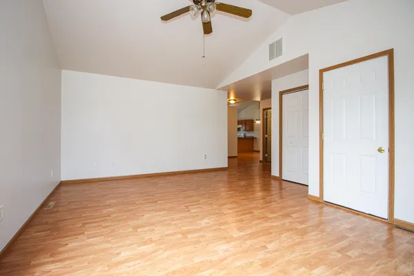 a view of an empty room with a ceiling fan