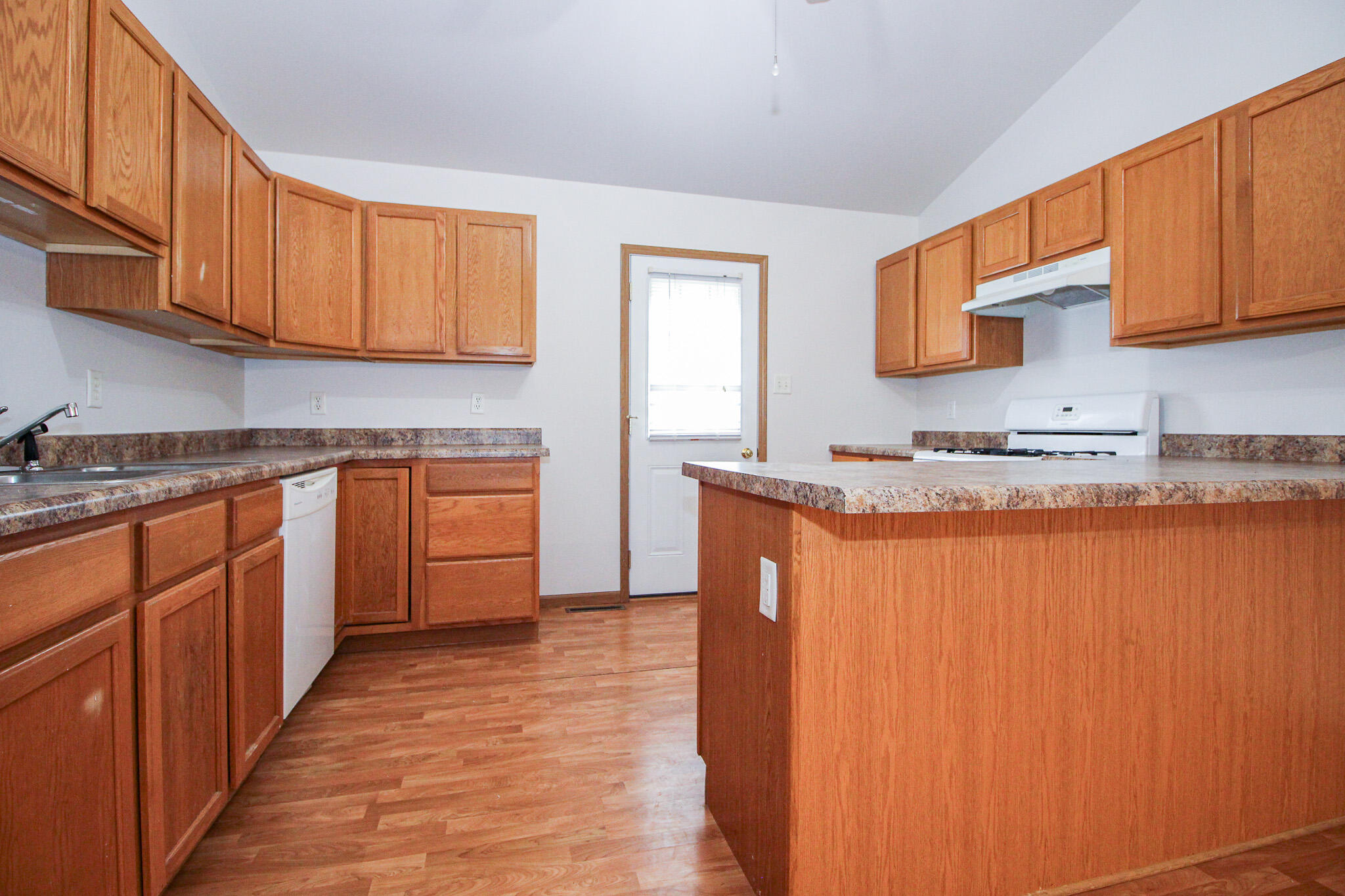 1709 Daisy Street Southeast De Motte, IN 46310 - Photo 7 of 19 a kitchen with stainless steel appliances granite countertop a sink stove and cabinets