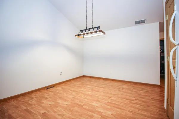 a view of a room with wooden floor