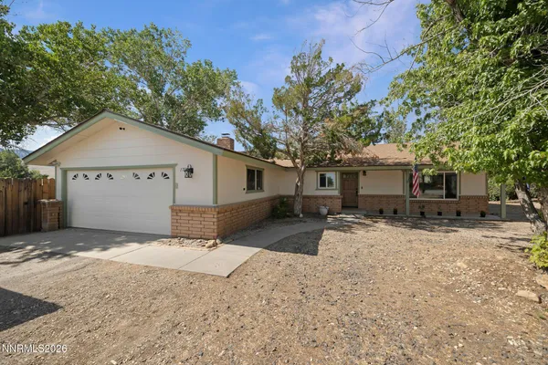 a view of a house with a yard and large tree