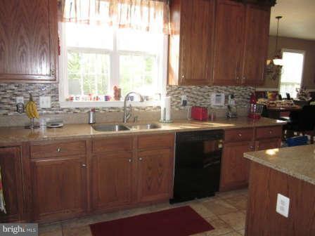 16501 Telescope Lane Dumfries, VA 22026 - Photo 11 of 30 a kitchen with a sink a window and cabinets